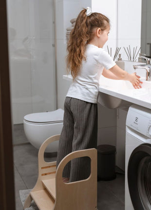 Kind staat op MIIMO in hoogte verstelbare opstap naturel om handen te wassen
