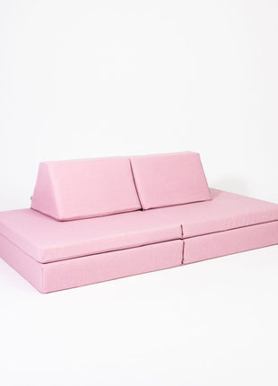 Roze Monboxy speelbank met twee rugkussens in schuin aanzicht op witte achtergrond.