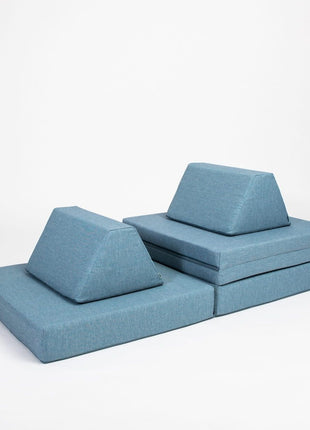 Turquoise Monboxy Montessori speelbank in multifunctionele speelopstelling met driehoekige rugkussens – bevordert actief spel.